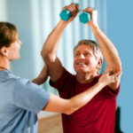 Mature Man Working With a Physical Therapist